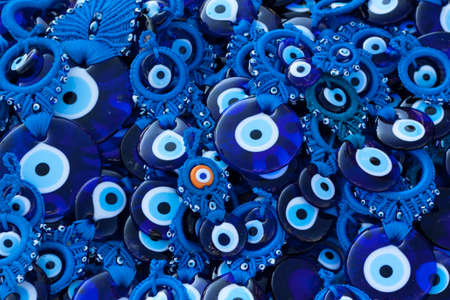 Blue glass eye on a pile as backgroundの写真素材