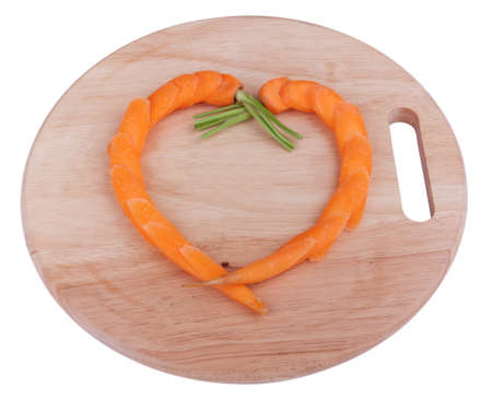 Carrots finely sliced on a chopping boardの写真素材