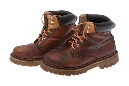 Old work boots in front of white background