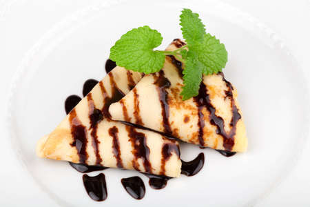 Closeup of pancakes garnished with chocolate sauce and lemon balmの写真素材