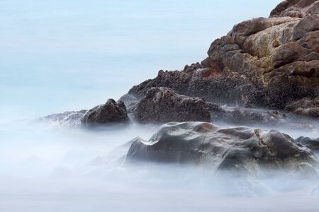 Rocks and sea on the beach of Patong in Phuket Thailandの写真素材