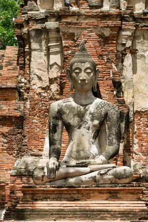 Buddha statue in the ancient historical temple complex Wat Mahathat in Ayutthaya, Thailandの写真素材
