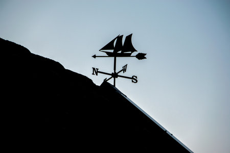 A wind direction sensor in the form of a ship on a roof