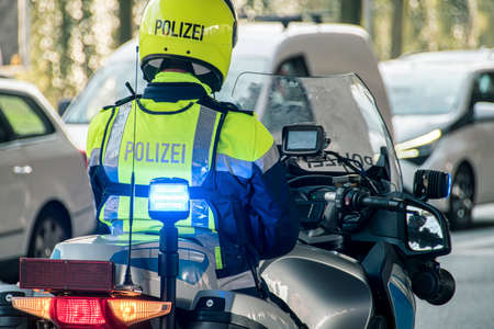 A policeman on his motorcycle enforces a roadblockの写真素材