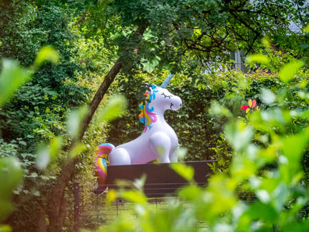 A life size plastic unicorn in a garden in the countrysideの写真素材