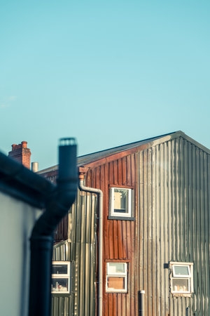 A relatively colorful corrugated iron house in a backyard.の写真素材