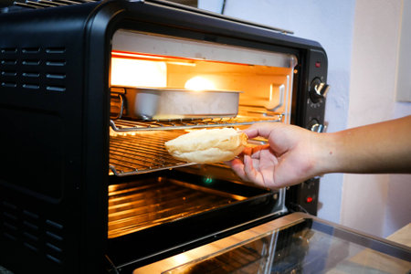 Baking bread in the electric ovenの写真素材