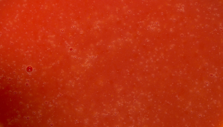 Dark red texture water with bubbles. Closeup. Tomato juiceの写真素材