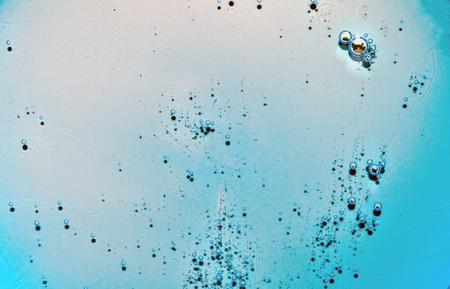 Light blue transparent texture of the liquid with bubbles. Light blue water with bubbles. Closeupの写真素材