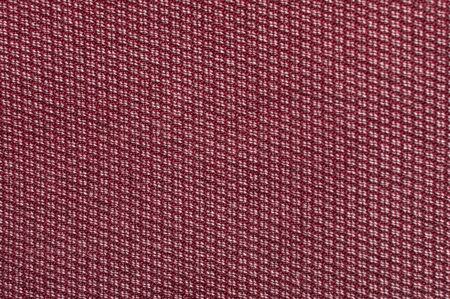 Red denim texture. Fabric texture for the clothing. Closeup