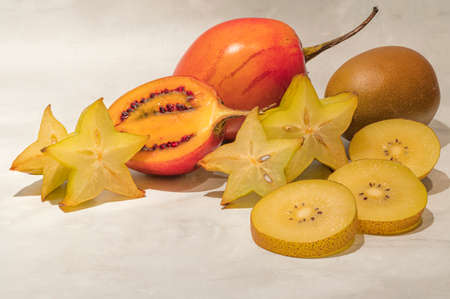 Still life with sliced kiwi, tamarillo and carambola fruitsの写真素材