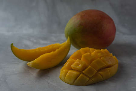 Still life with delicious juicy sliced mangoの写真素材