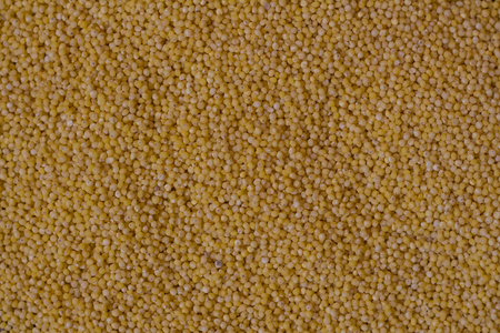 Millet. Top of the page view Millet groats on wood background and burlap top view