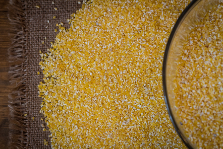 Top corn view on wood background and burlap top viewの写真素材