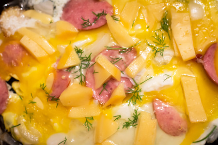 Scrambled eggs with dill cheese and sausage sliced