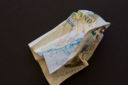 A crumpled British five pound noteの写真素材