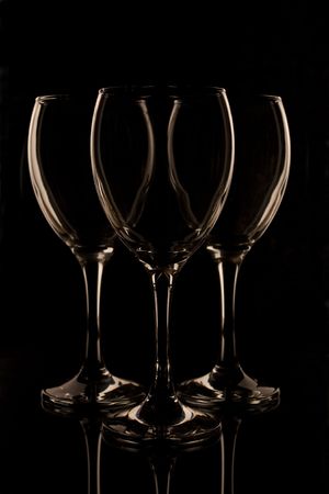 Three empty wine glasses against a black backgroundの写真素材