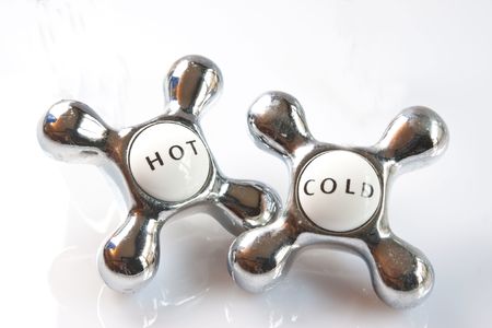 Hot and cold tap handles isolated against a white background