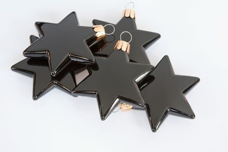 Black star-shaped Christmas tree decorations isolated in the studio