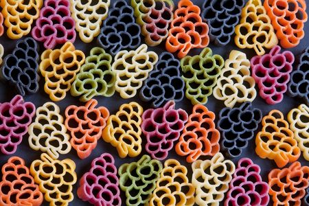 Dried grape-shaped pasta naturally coloured with vegetables & squid inkの写真素材