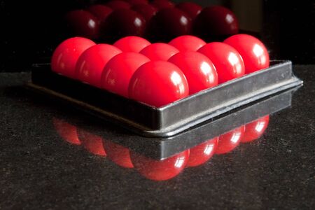 A snooker triangle frame filled with red ballsの写真素材