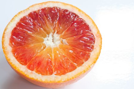 Half a blood orange isolated against a white backgroundの写真素材