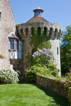 The tower of an English castle, with ivy and lilacsの写真素材