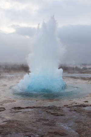 Geysir erupting at Strokkur, Iceland on a cold winter's dayの写真素材