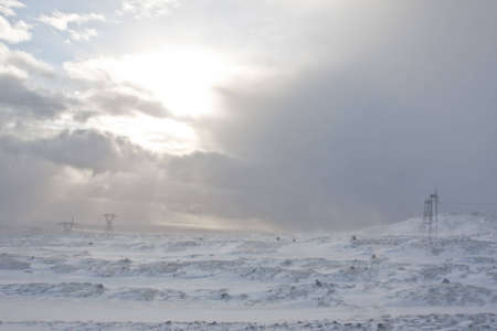 Electric Pylons on Hellisheidi Moor, between Reykjavik & Selfoss, during a break in a blizzardの写真素材
