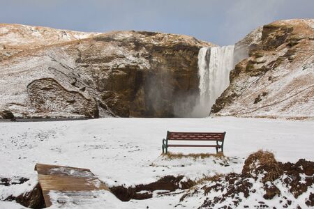 Skogafoss waterfalls in Iceland on a snowy dayの写真素材