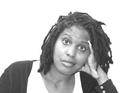 A young Black woman with dreads with her head tilted.の写真素材