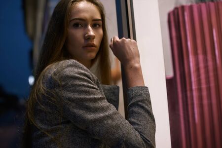 Girl in grey suit posing on the town streetの写真素材