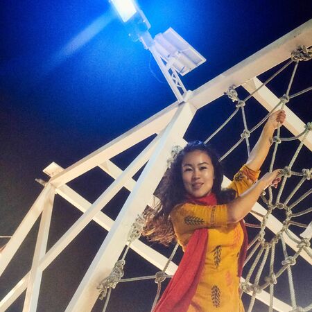 Asian girl climbing on the rope net on playgroundの写真素材