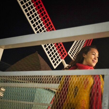 Asian girl posing infront of the mill on playgroundの写真素材