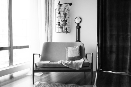Cozy modern home with comfortable sofa and a light window.の写真素材