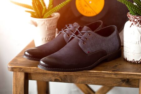 Men's dark blue shoes on wooden table. Fahion still-life boots. Classic accessory for a businessman.の写真素材