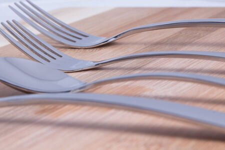 Cutlery on background bamboo board, plug in focus