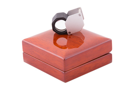 Jeweler magnifier on wooden boxの写真素材
