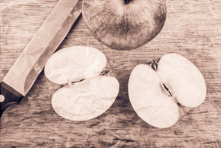 Cut apple in a retro style on a cutting boardの写真素材