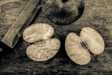 Cut apple in a retro style on a cutting boardの写真素材