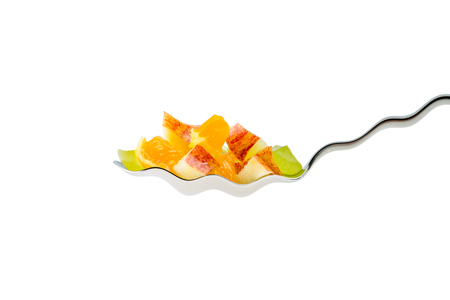 fruit in a spoon isolated on white backgroundの写真素材
