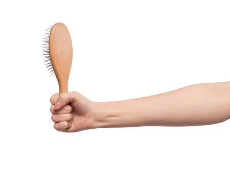 A hairbrush in a female handの写真素材