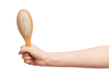 A hairbrush in a female handの写真素材