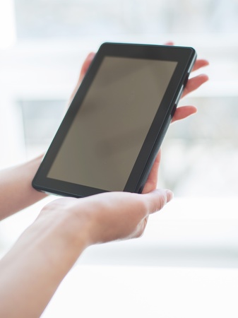 Pretty young woman is using a Tablet PCの写真素材