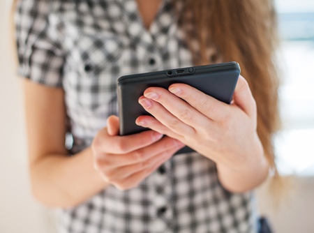Pretty young woman is using a Tablet PC
