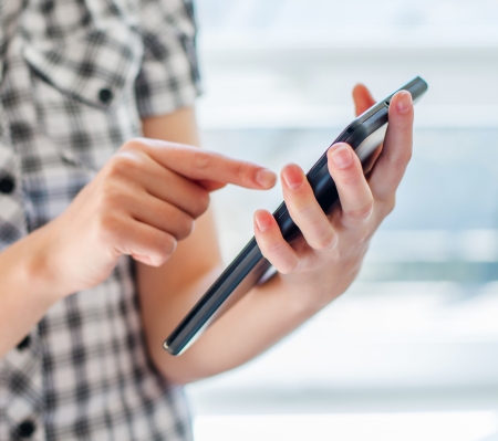 Pretty young woman is using a Tablet PCの写真素材