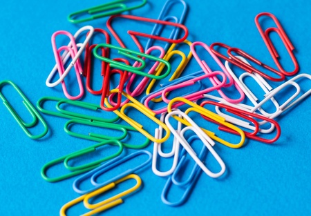 Paper clips on a blue backgroundの写真素材
