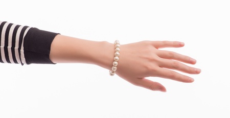 Delicate woman's hand with a braceletの写真素材