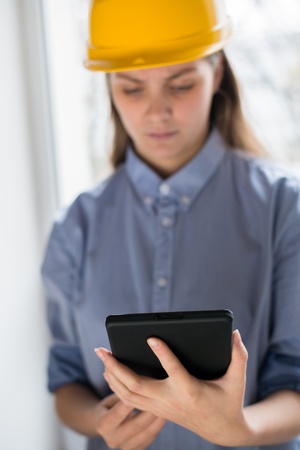 A woman in a helmet with a Tablet PC