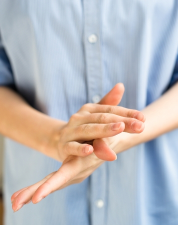 Woman rubbing her handsの写真素材